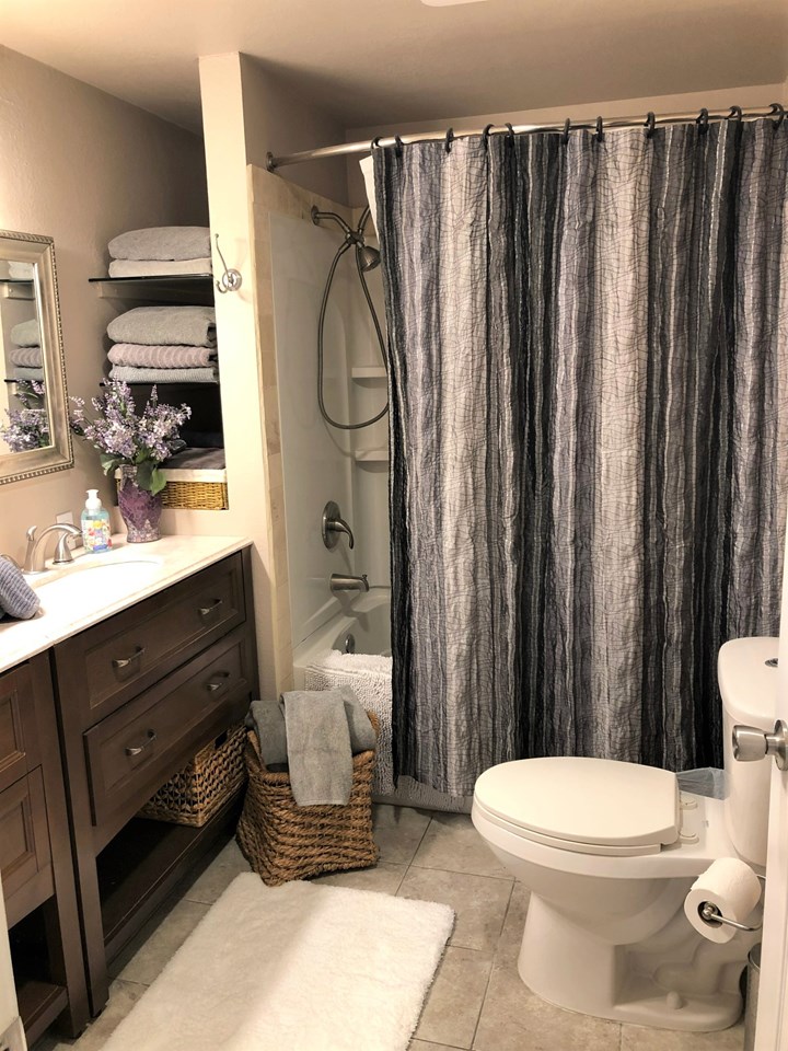 downstairs bathroom with tiled flooring & dual vanity