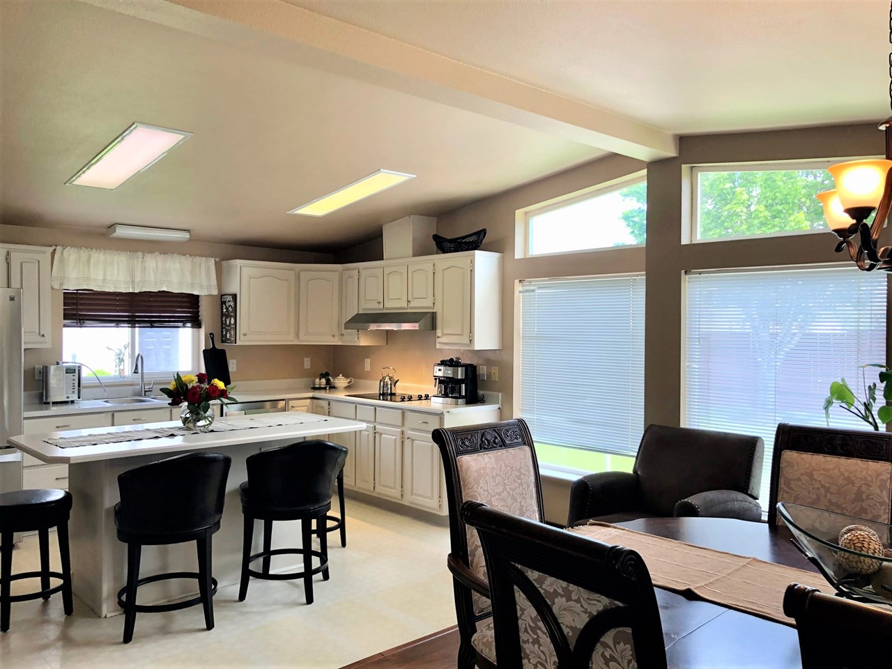 so much natural light with large picture windows around dining area
