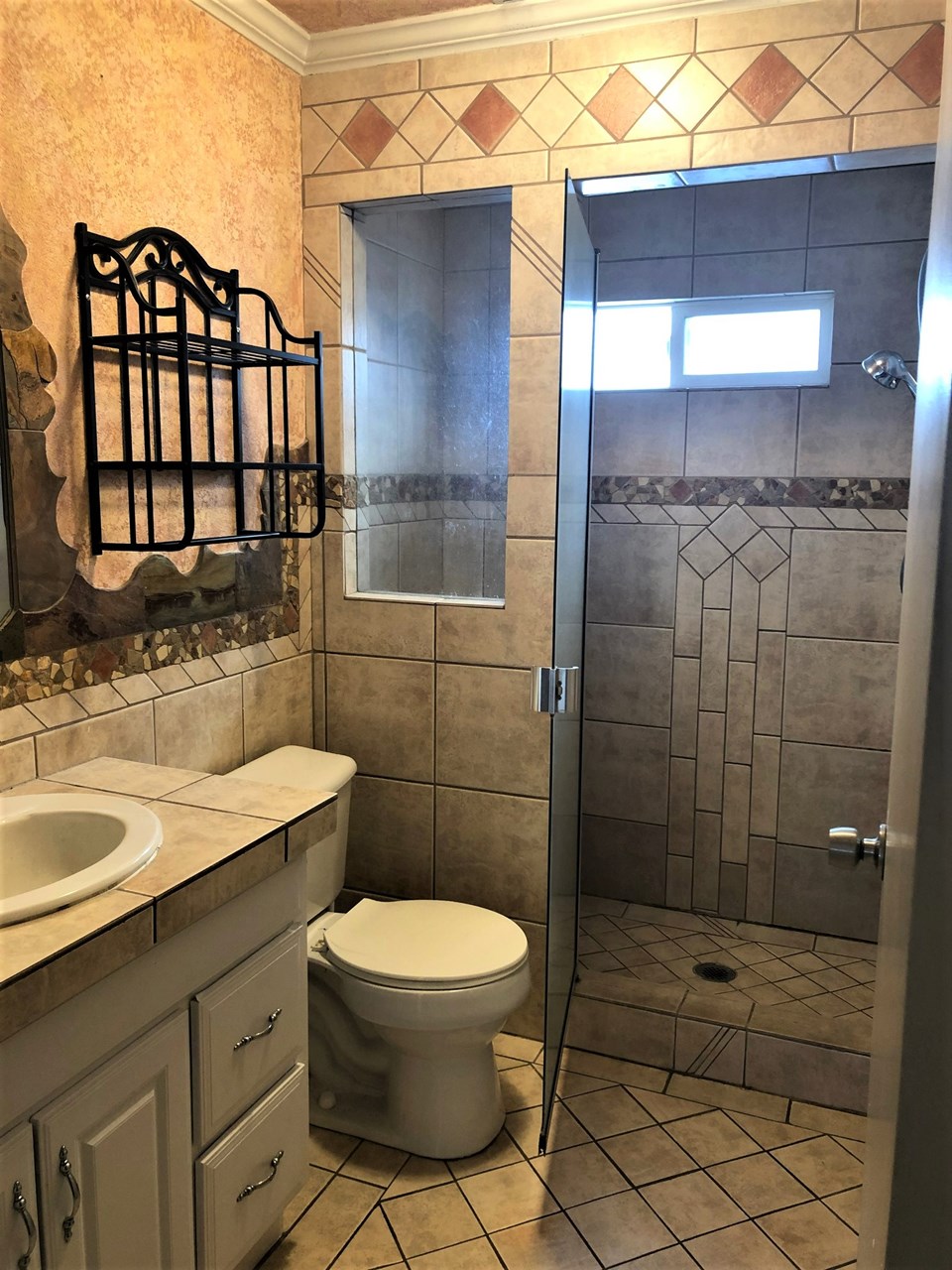 main level bathroom with tiled shower