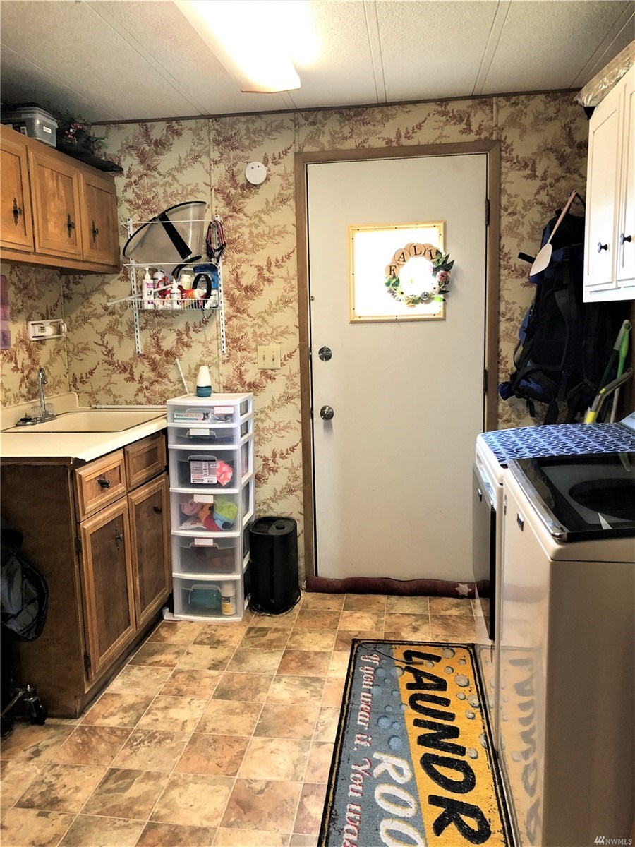 laundry room with wash basin, leads out to brand new built porch
