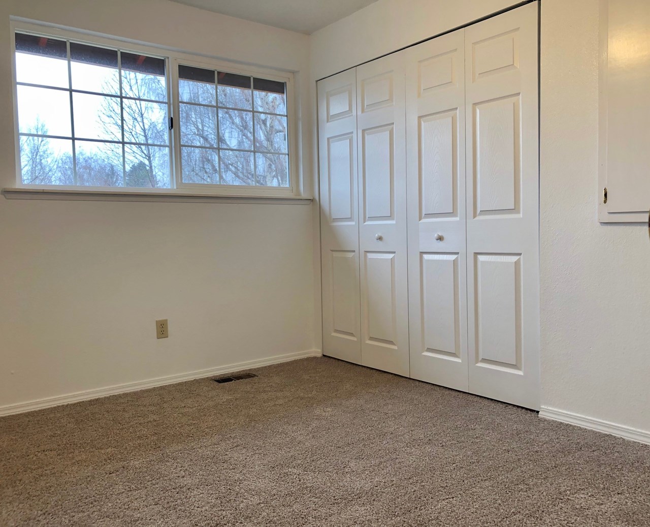 bedroom bedroom has new carpeting and new white panel closet doors