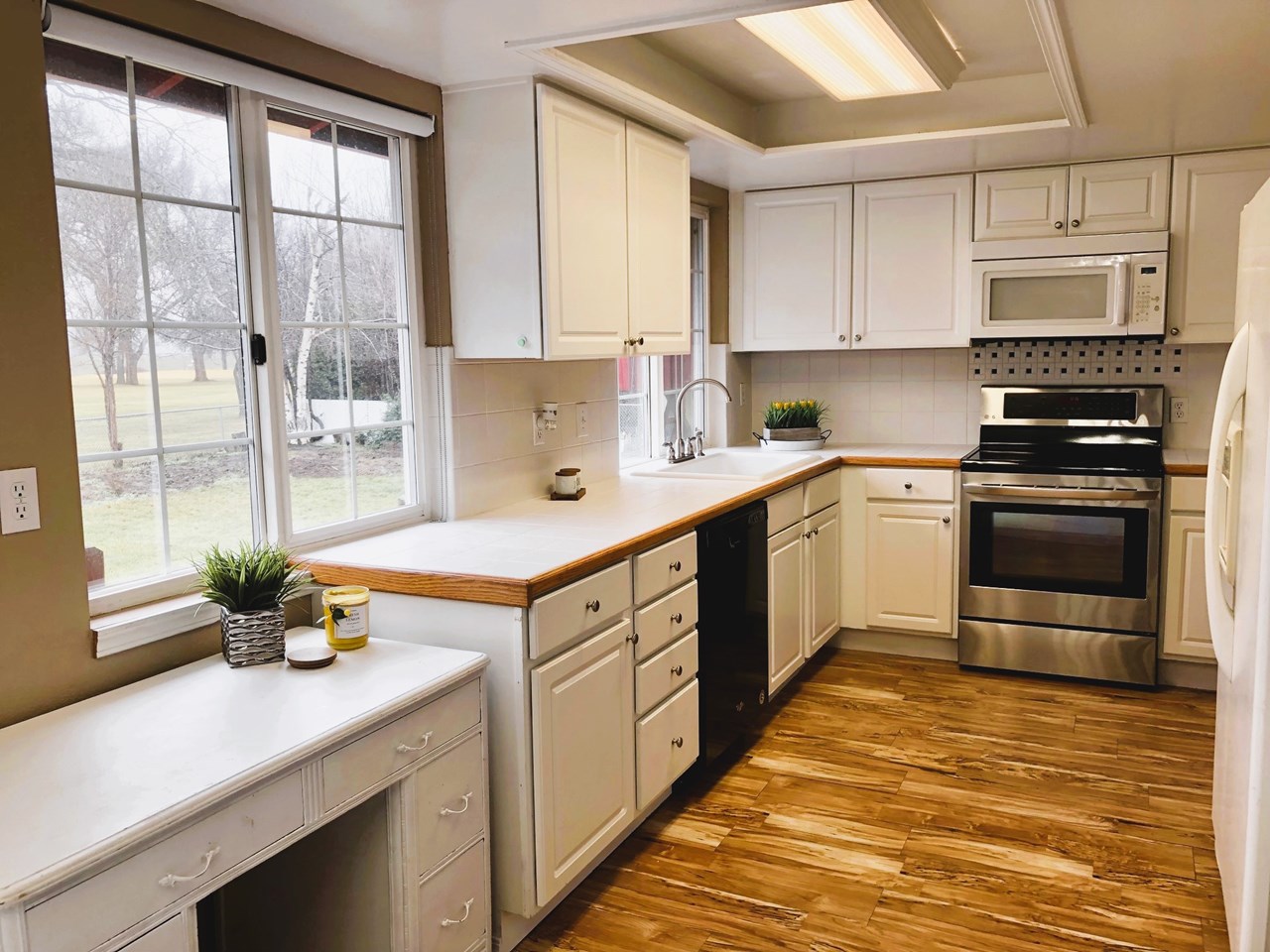 kitchen white cabinetry with full appliance package included